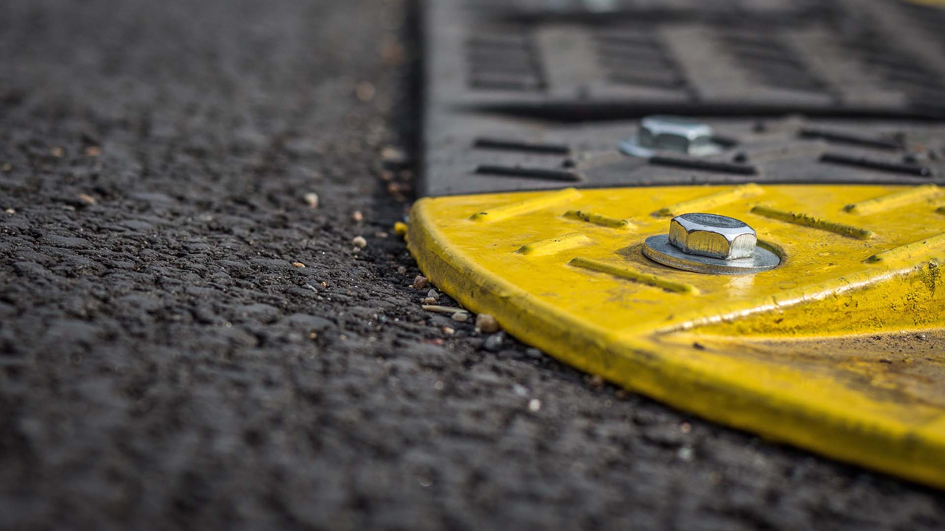 Grey and yellow speed bump close up