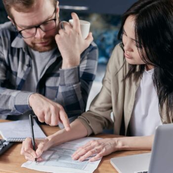 couple calculating bills at table