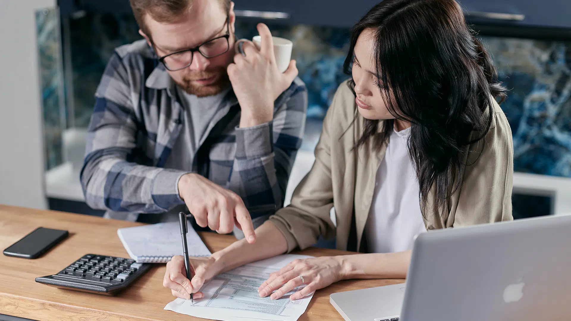 couple calculating bills at table