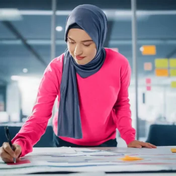 female entrepreneur working at architectural drawing desk