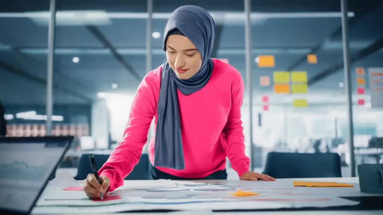 female entrepreneur working at architectural drawing desk