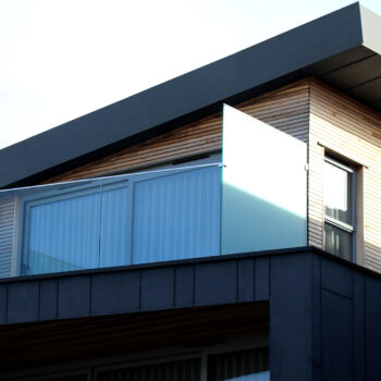 Exterior of a modern wood and glass office building on a blue sky