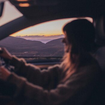 Woman driving at sunset on the west coast