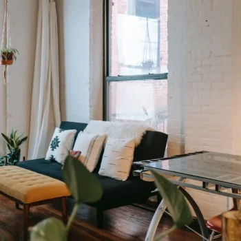 living room in older home with painted exposed brick walls