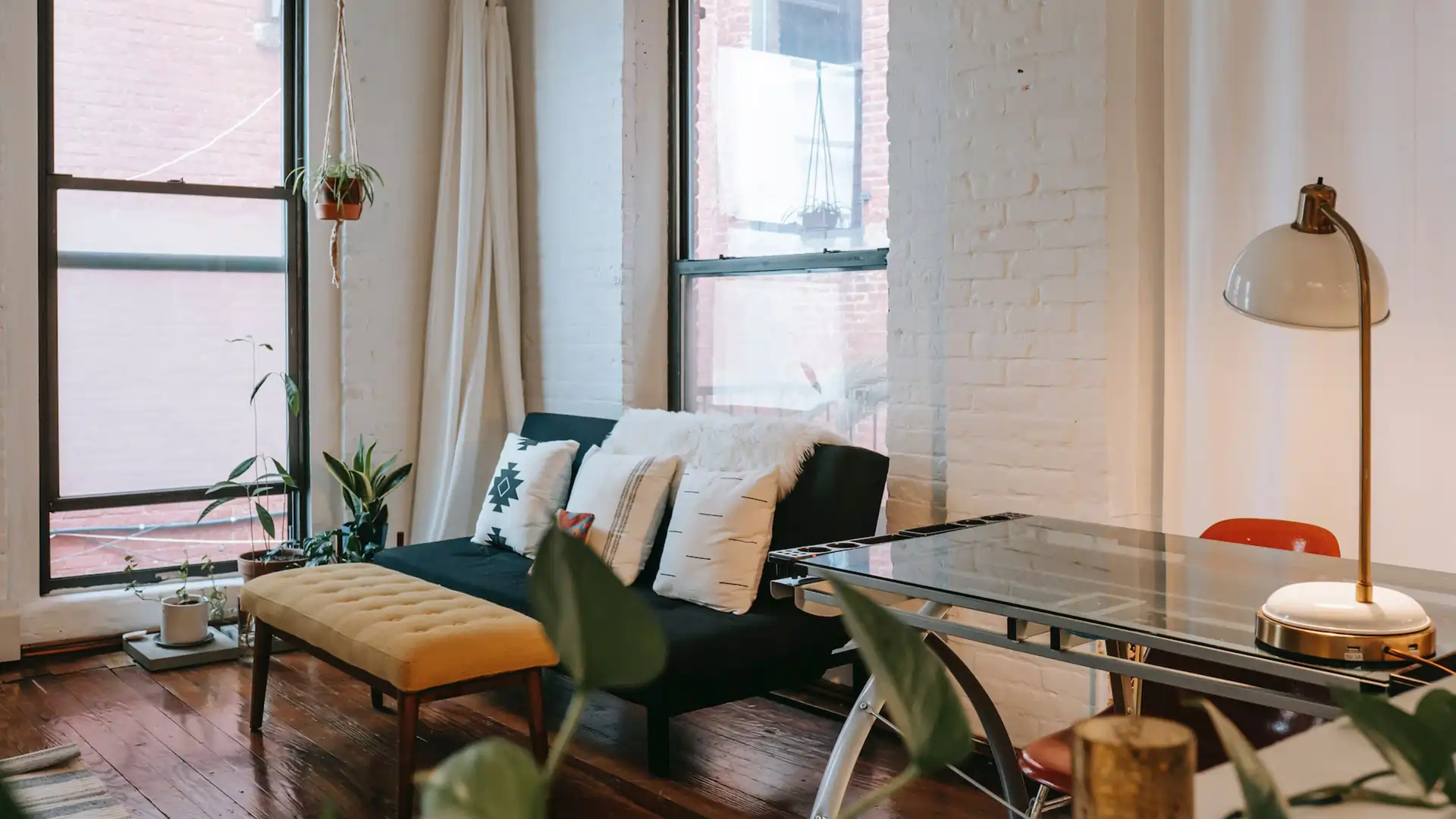 living room in older home with painted exposed brick walls