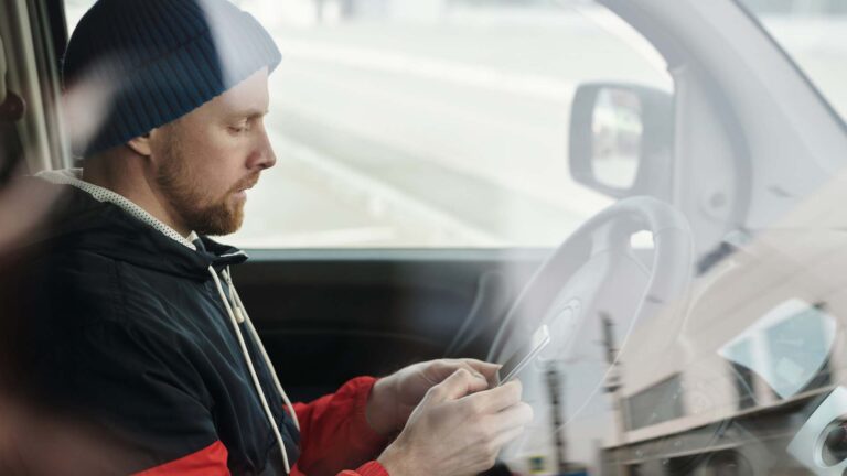 Man in Red and Black Jacket Wearing Blue Knit Cap