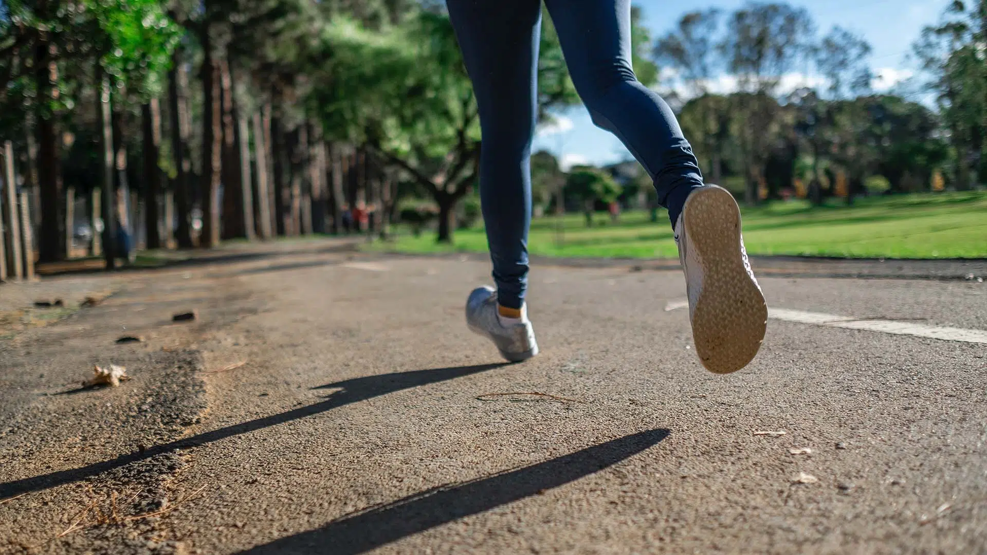 Close up on the running shoes of a person running