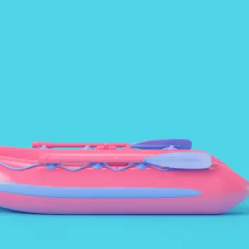 Inflatable pink boat on blue background.