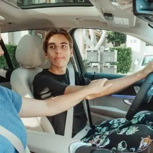 mother and son in a car learning to drive