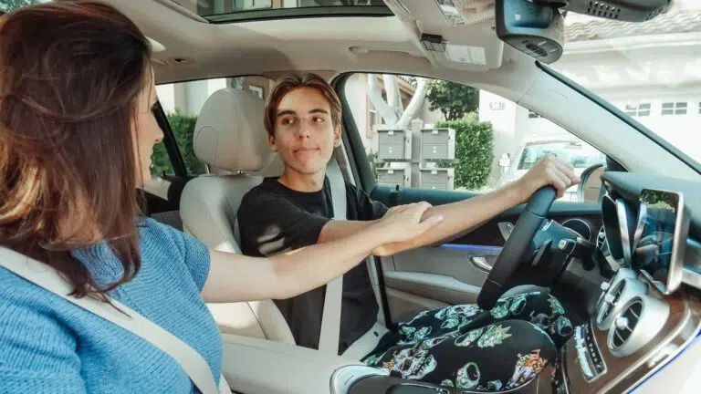 mother and son in a car learning to drive