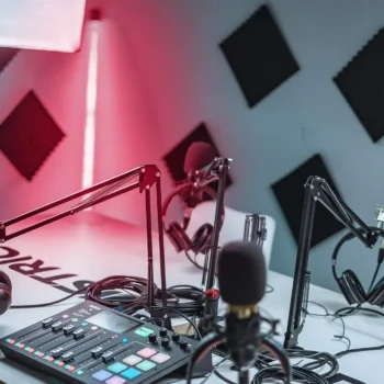 podcast studio with microphones and soundboard