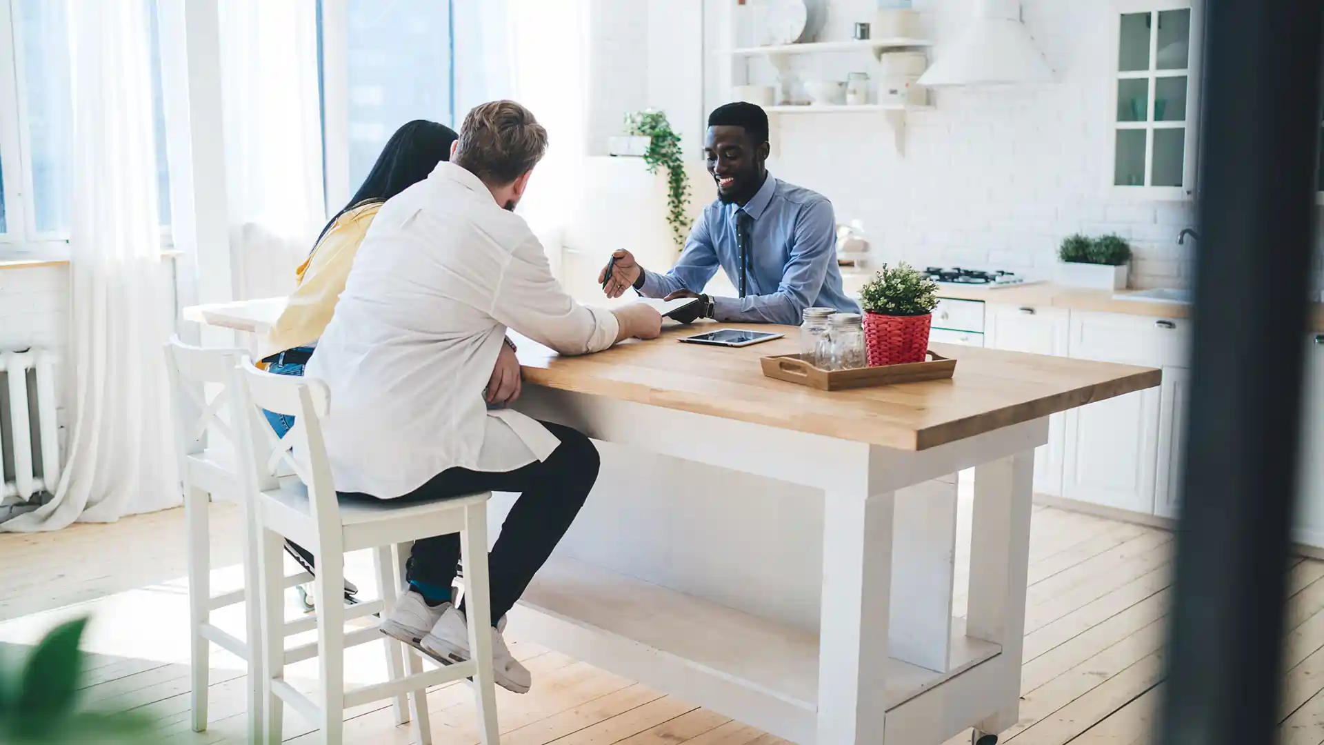 couple meeting with broker in kitchen