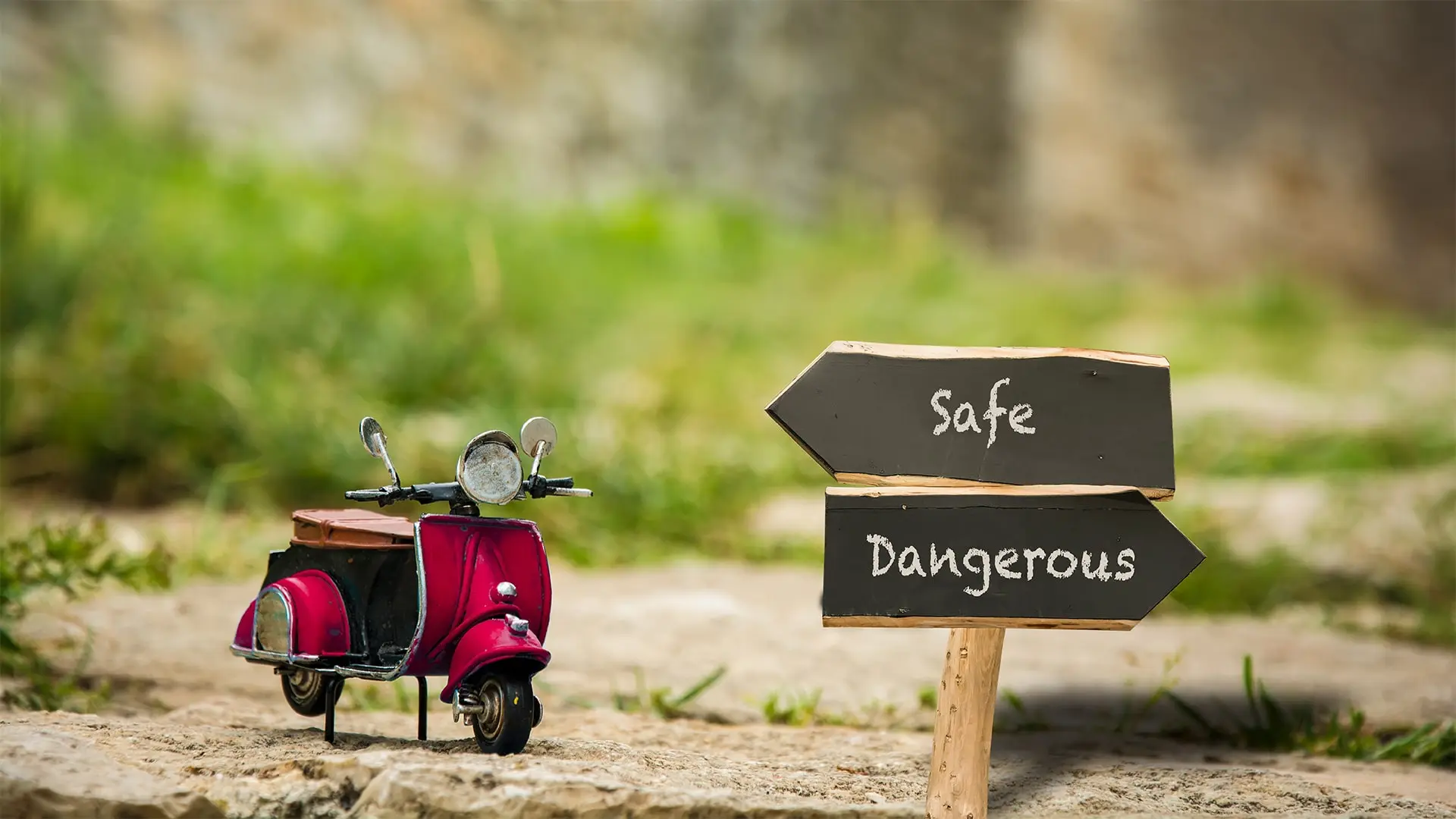 toy moped with sign indicating safety and danger