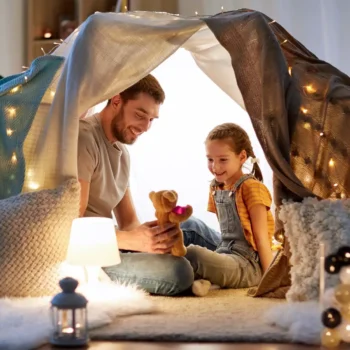 Father and daughter playing together at home.