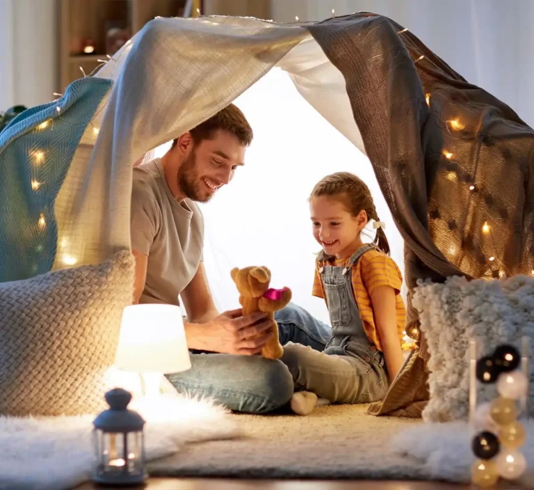 Father and daughter playing together at home.