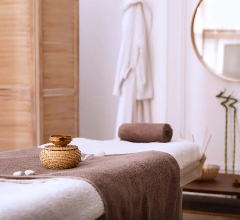 massage table in home based business with bathrobe hanging on the wall