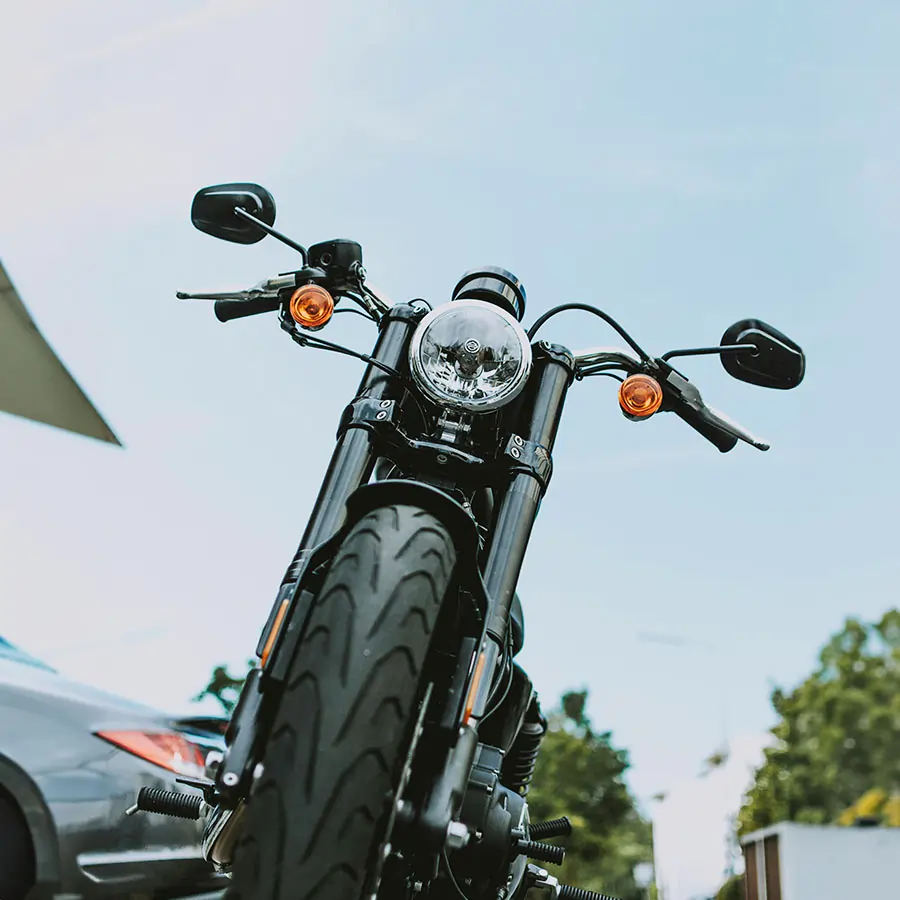 Motorcycle in driveway with car.