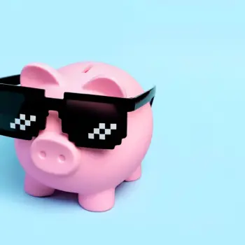 Pink ceramic piggy bank wearing pixel shades.