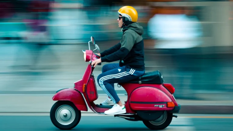 rider on moped with yellow helmet