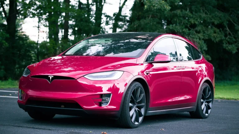 raspberry tesla parked on road