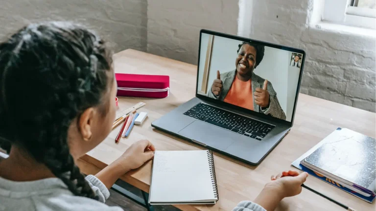 person speaking to other person on laptop