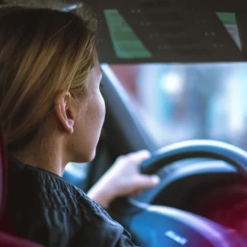 young driver behind steering wheel of car