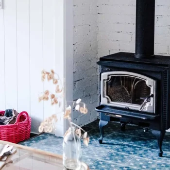 wood burning stove in room with pink basket