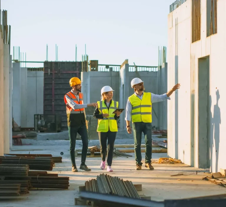 General contractor walking through a site with architect and engineer.