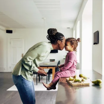 Mom and daughter sharing a loving moment in their kitchen.