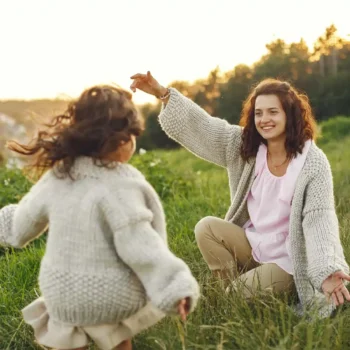 Young child running into the arms of their mom.