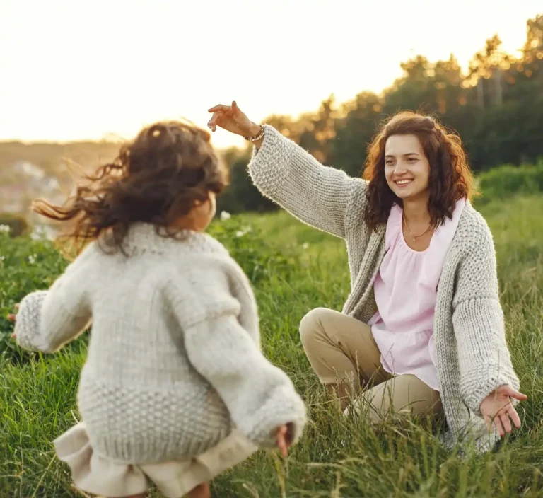 Young child running into the arms of their mom.