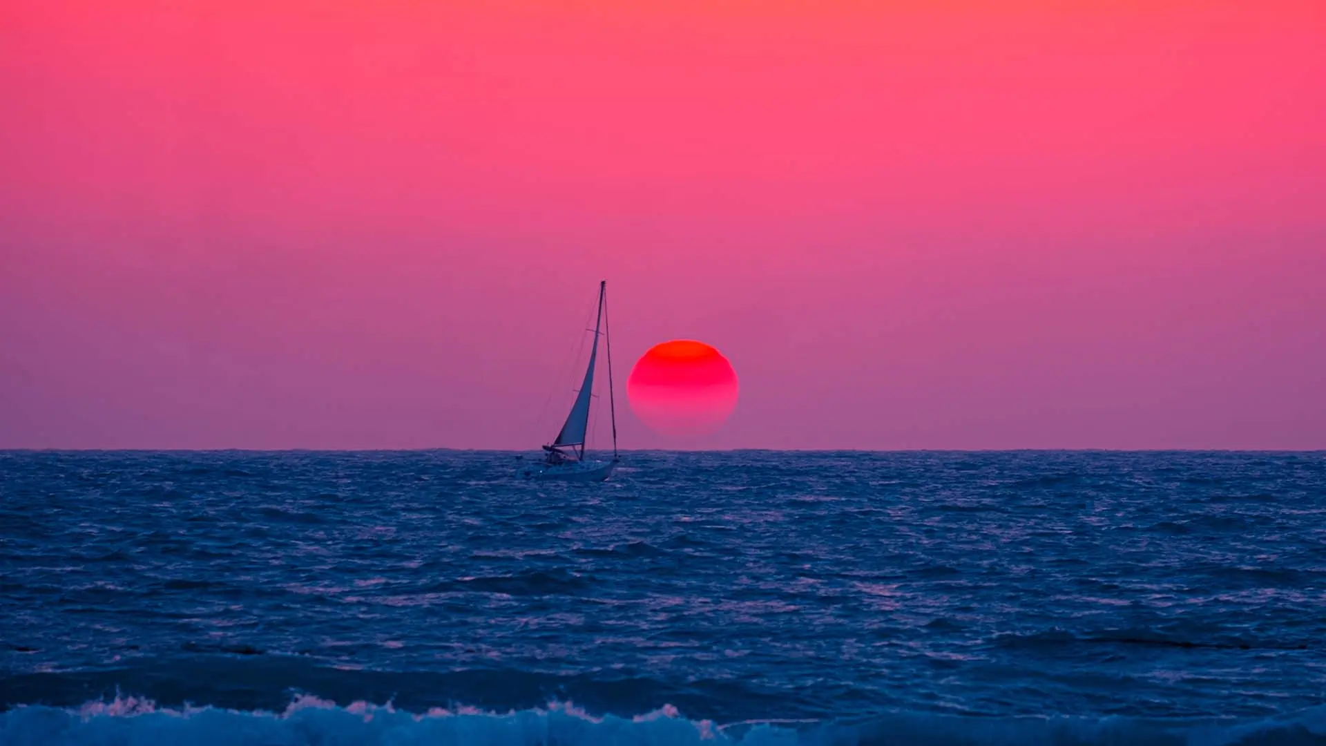 Sailboat in the water at sunset.