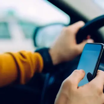 Distracted driver texting while behind the wheel.