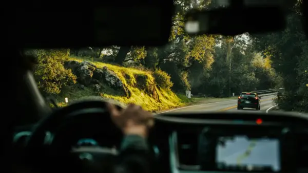 Driver driving behind a car.