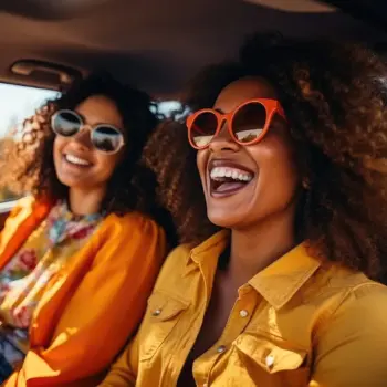 Two women parked in their car.