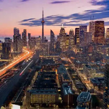 Cars driving in Toronto cityscape.